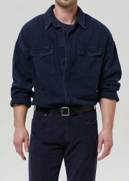 Dark navy button-up shirt on a grey background.
