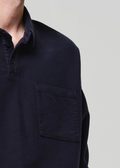 Navy blue long-sleeve shirt with a pocket on a light gray background