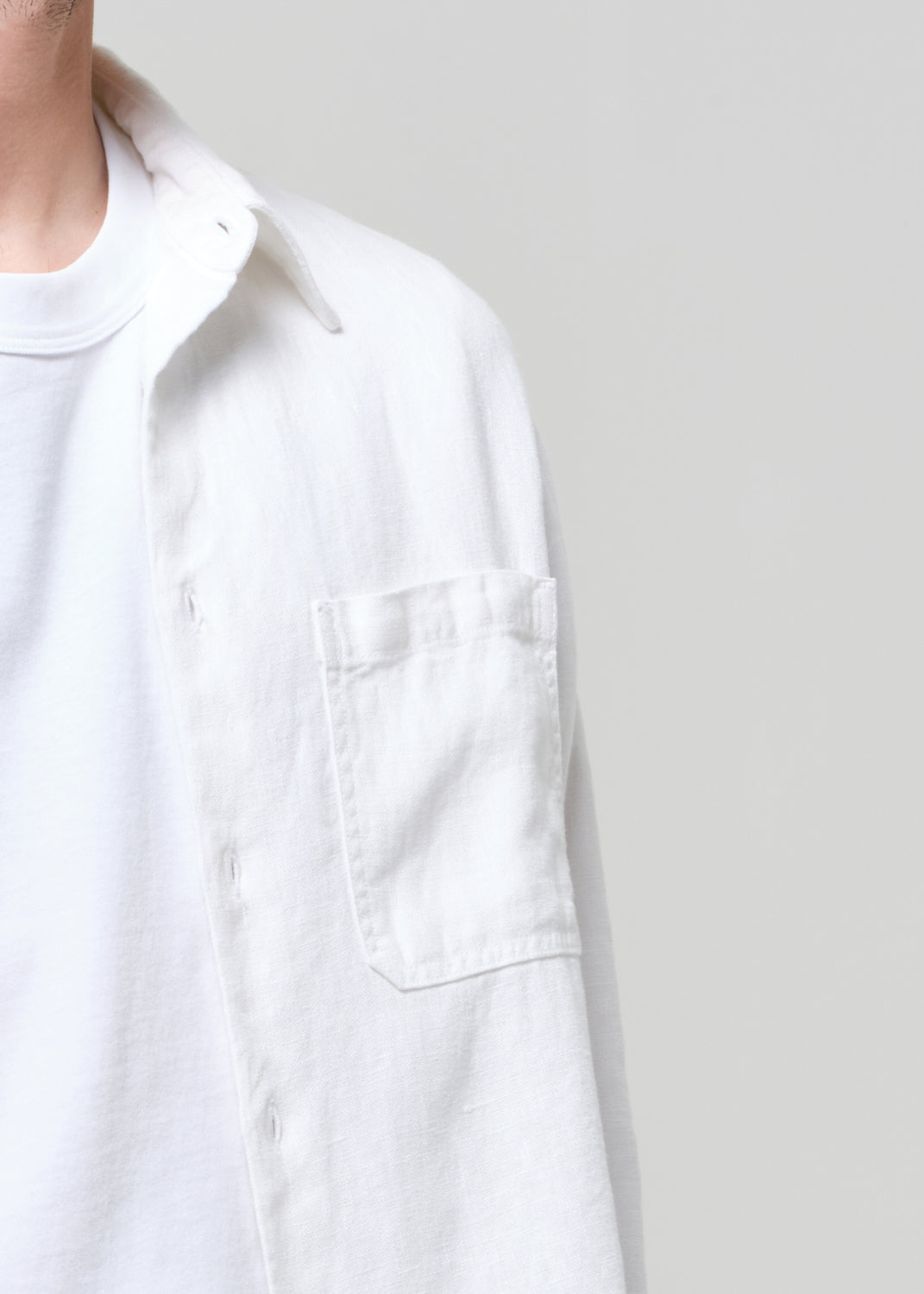 White shirt worn by a person on a plain background