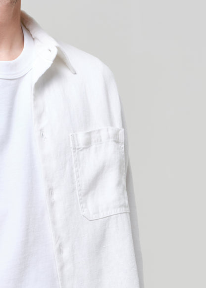 White shirt worn by a person on a plain background
