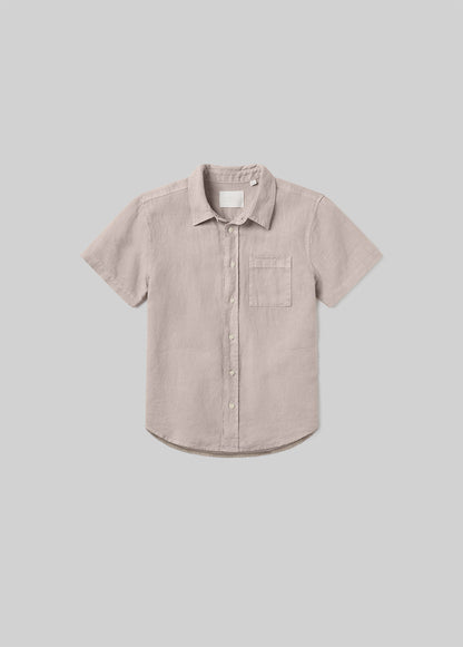 Wheat beige short sleeve button-up shirt with a pointed collar, front button closure, and single chest pocket, front flat lay view on a grey background.