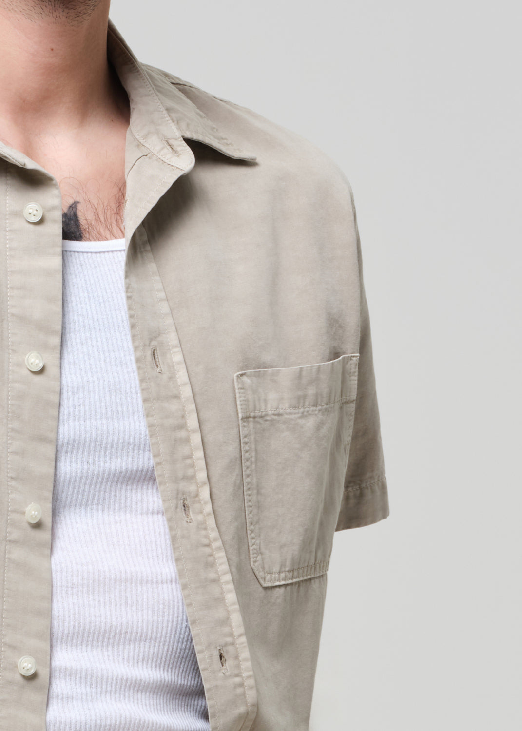 Beige shirt with a pocket on a plain background
