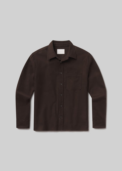 Flat lay of brown shirt on a grey background
