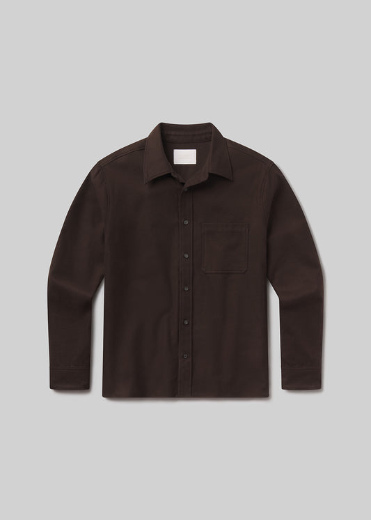 Flat lay of brown shirt on a grey background