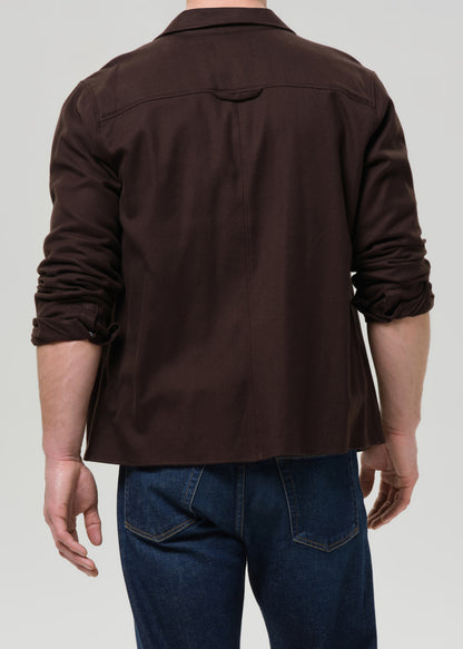 Brown shirt worn by a person on a grey background
