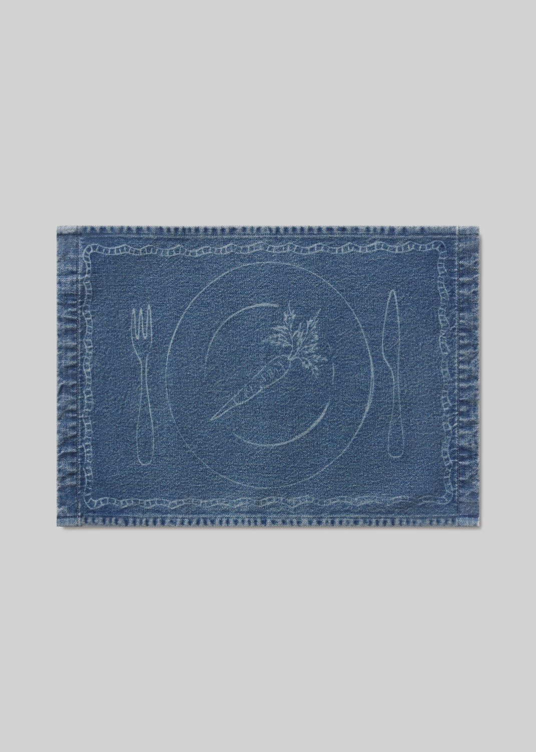 Blue denim placemat with carrot ,cutlery and plate design on a light gray background