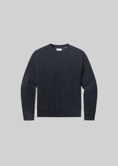Flat lay of black sweatshirt on a grey background