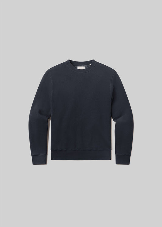 Flat lay of black sweatshirt on a grey background