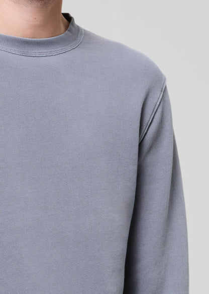 Gray sweatshirt worn by a person on a light gray background