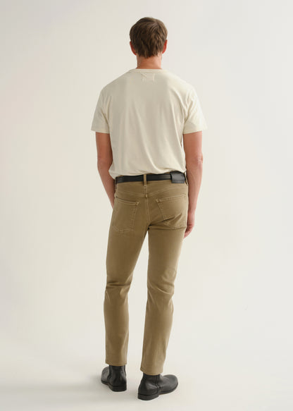 Person wearing ecru short sleeve crewneck t-shirt with tan pants and black belt, back view.
