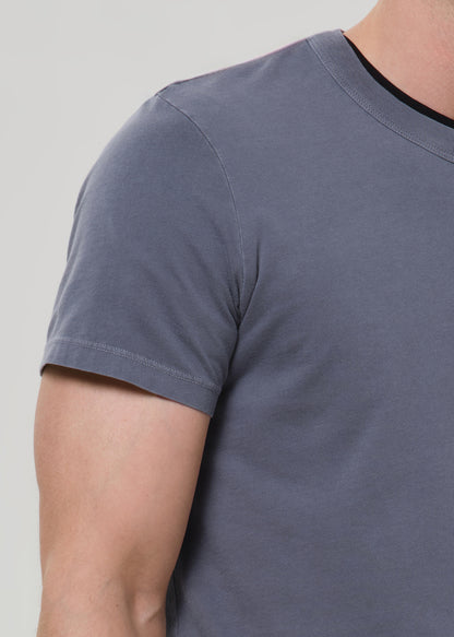 Gray t-shirt worn by a person on a light gray background