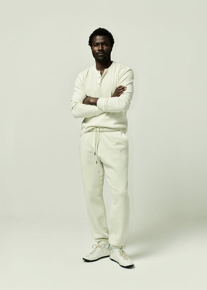 Person wearing a off-white henley paired with matching colot pants