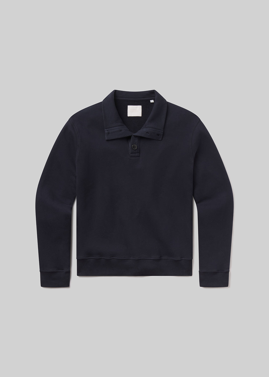 Flat shot of black sweater with collar on a grey background