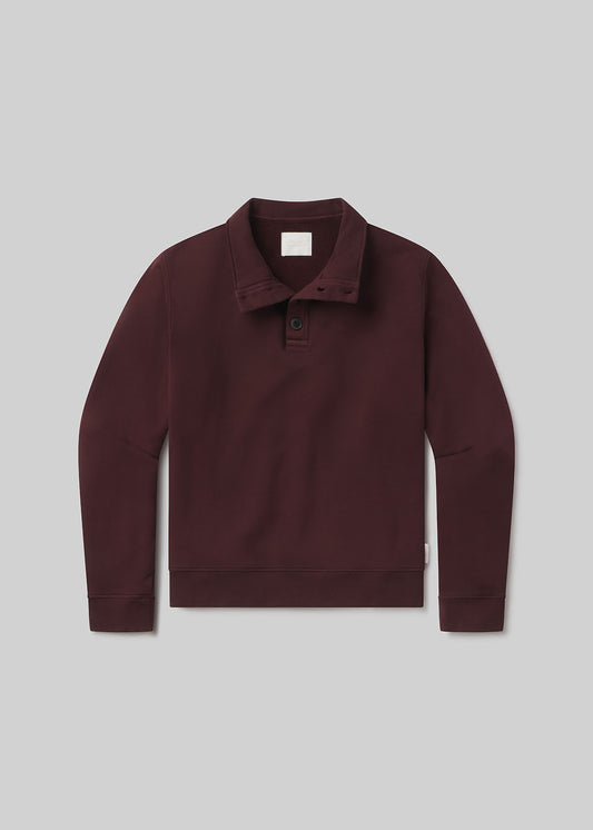 Burgundy half-button pullover on grey background