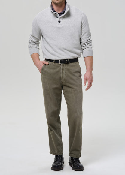 Man wearing a gray sweater and khaki pants on a grey background