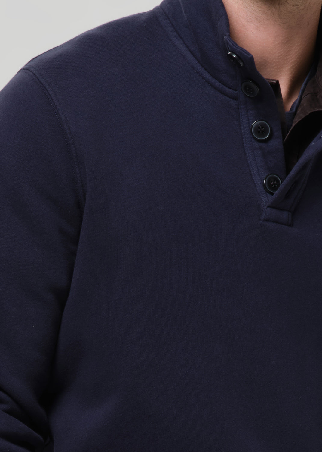 Navy blue button-up shirt on a grey background
