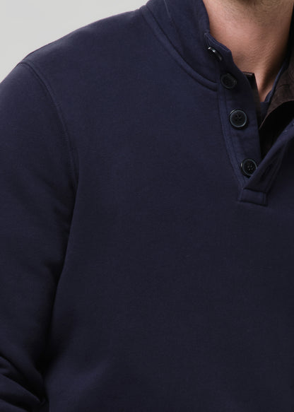 Navy blue button-up shirt on a grey background
