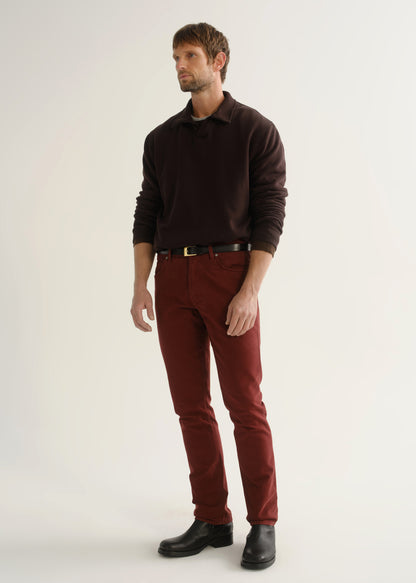 Person wearing dark brown rugby pullover and burgundy pants front three-quarter view