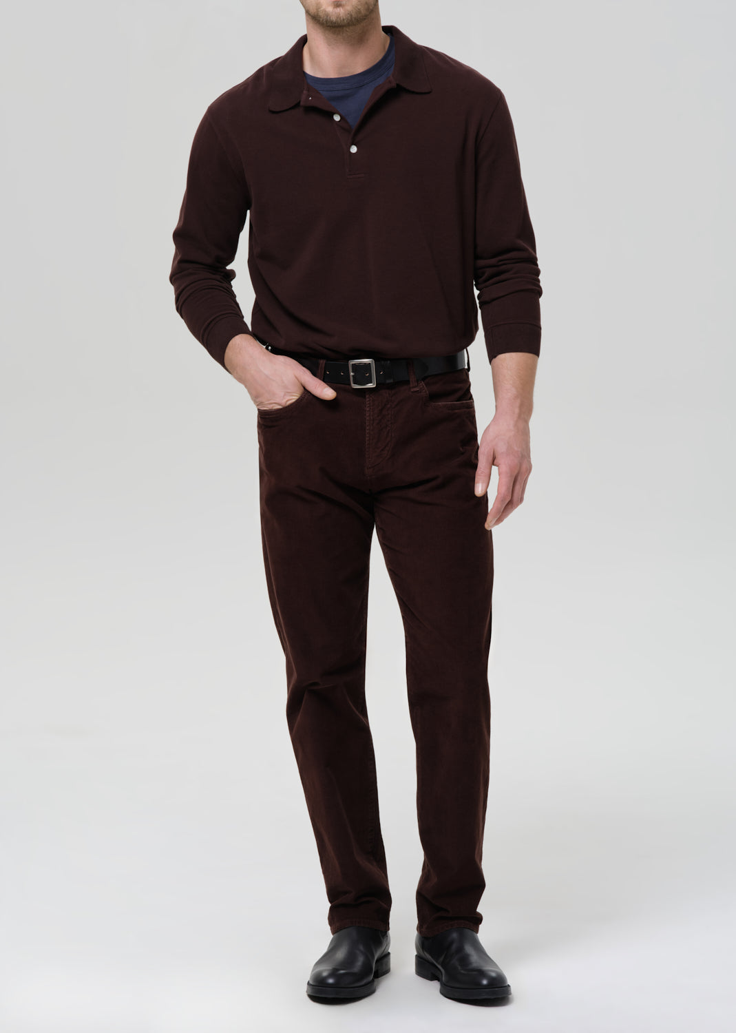 Man wearing a brown outfit with a grey background