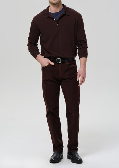 Man wearing a brown outfit with a grey background